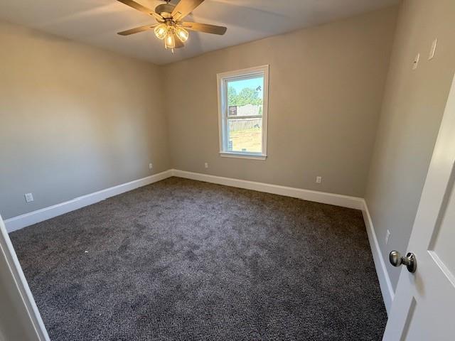 53357 Phillips Path, Loranger, LA 70446 - empty room with a ceiling fan and dark carpet
