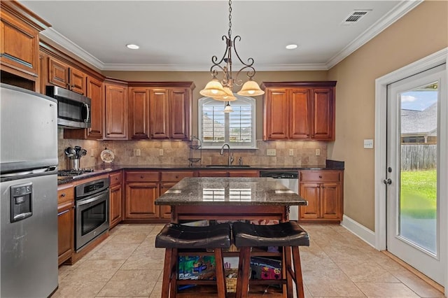 1521 Rue De Fontaine, Covington, LA 70433 - kitchen with appliances with stainless steel finishes, brown cabinetry, decorative backsplash, light tile patterned floors, and crown molding