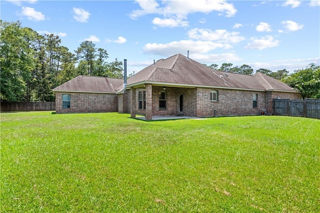1521 Rue De Fontaine, Covington, LA 70433 - rear view of property featuring a patio area, a fenced backyard, brick siding, and a shingled roof