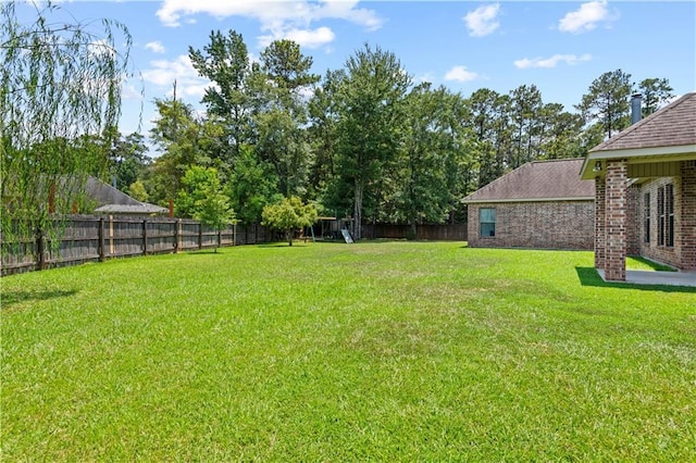 1521 Rue De Fontaine, Covington, LA 70433 - fenced backyard featuring a playground