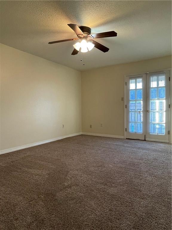 51 Brandon Hall Dr, Destrehan, LA 70047 - carpeted empty room with a ceiling fan and a textured ceiling