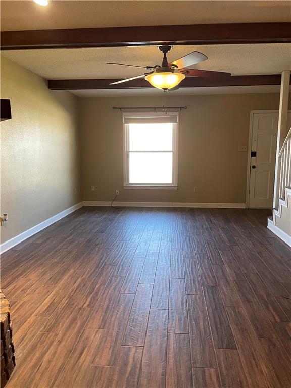 51 Brandon Hall Dr, Destrehan, LA 70047 - unfurnished room featuring stairway, a ceiling fan, dark wood finished floors, and beamed ceiling