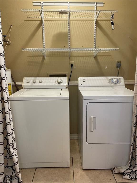 51 Brandon Hall Dr, Destrehan, LA 70047 - laundry area with washing machine and clothes dryer, light tile patterned flooring, and water heater