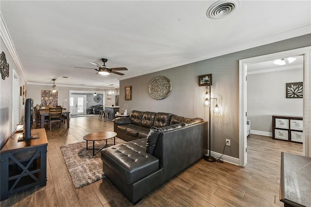 5028 Jasper St, Metairie, LA 70006 - living area with wood finished floors, ceiling fan, and ornamental molding