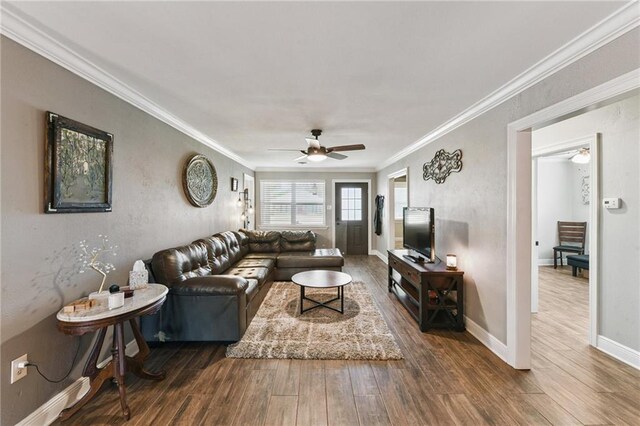 5028 Jasper St, Metairie, LA 70006 - living room featuring ceiling fan, dark wood-style floors, and ornamental molding