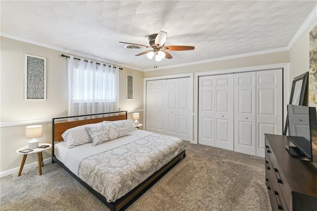 5028 Jasper St, Metairie, LA 70006 - carpeted bedroom featuring multiple closets, ceiling fan, and ornamental molding