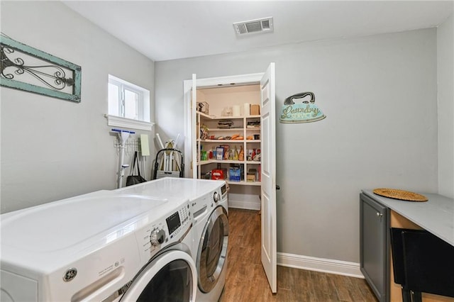 5028 Jasper St, Metairie, LA 70006 - laundry area featuring washing machine and clothes dryer and dark wood-type flooring