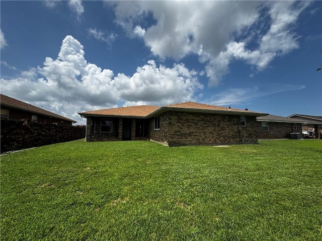 5301 E Idlewood Ct, New Orleans, LA 70128 - rear view of property with a yard and brick siding