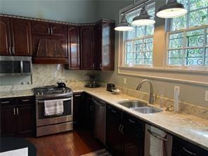 400 Millaudon St, New Orleans, LA 70118 - kitchen featuring appliances with stainless steel finishes, premium range hood, light countertops, and dark brown cabinetry