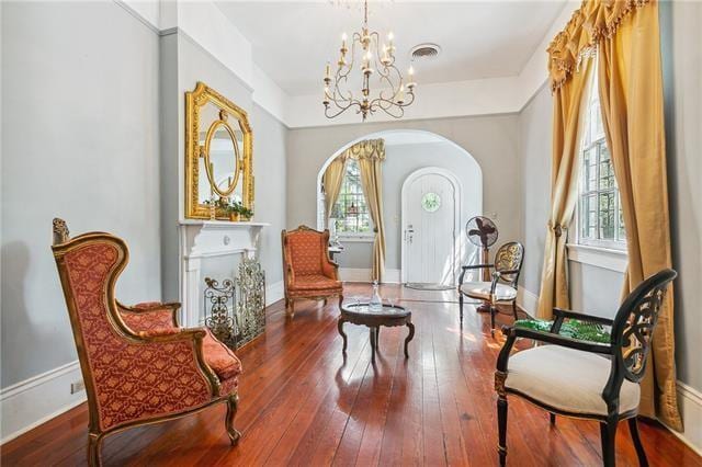 400 Millaudon St, New Orleans, LA 70118 - sitting room with healthy amount of natural light, a chandelier, hardwood / wood-style floors, and arched walkways