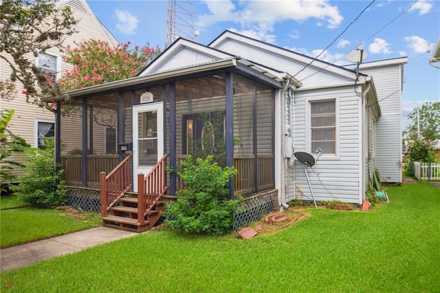 5225 Conti St, New Orleans, LA 70124 - view of front facade with a front yard and a sunroom