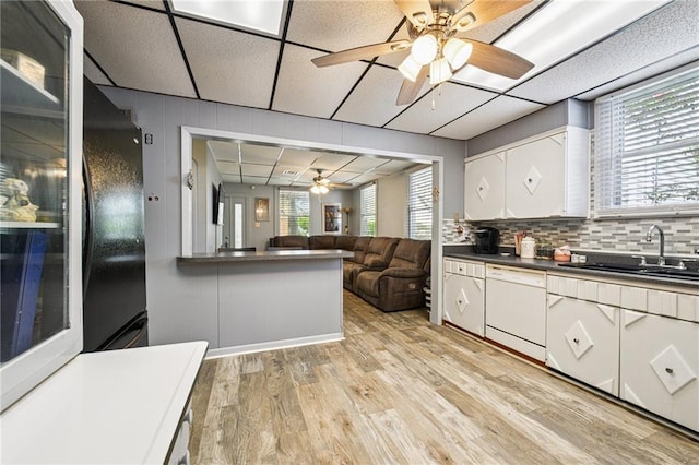 5225 Conti St, New Orleans, LA 70124 - kitchen featuring white dishwasher, ceiling fan, dark countertops, light wood finished floors, and white cabinetry