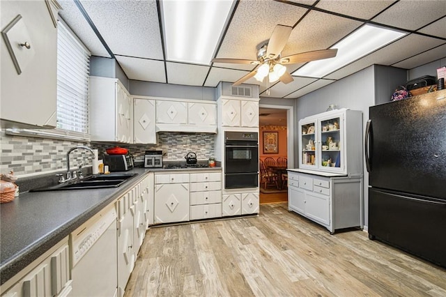5225 Conti St, New Orleans, LA 70124 - kitchen featuring black appliances, a warming drawer, a ceiling fan, light wood finished floors, and dark countertops