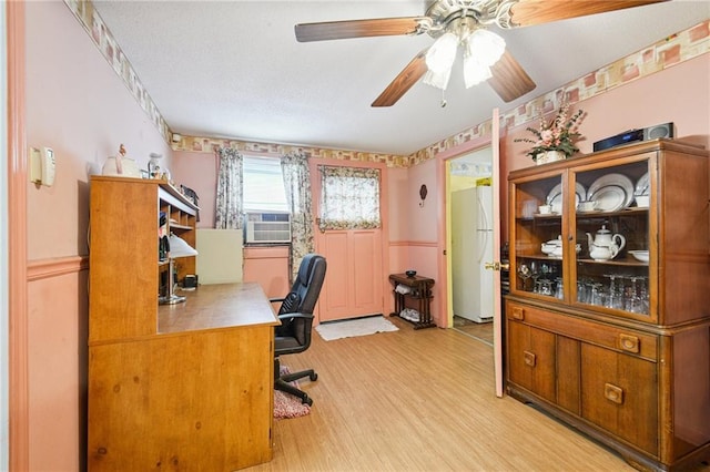 5225 Conti St, New Orleans, LA 70124 - office space featuring ceiling fan, light wood-style floors, cooling unit, and a textured ceiling