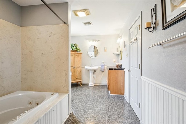 5225 Conti St, New Orleans, LA 70124 - full bathroom featuring a tub with jets and tile patterned floors