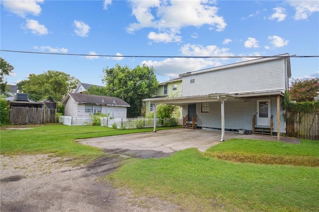 5225 Conti St, New Orleans, LA 70124 - rear view of house featuring entry steps, a carport, and driveway
