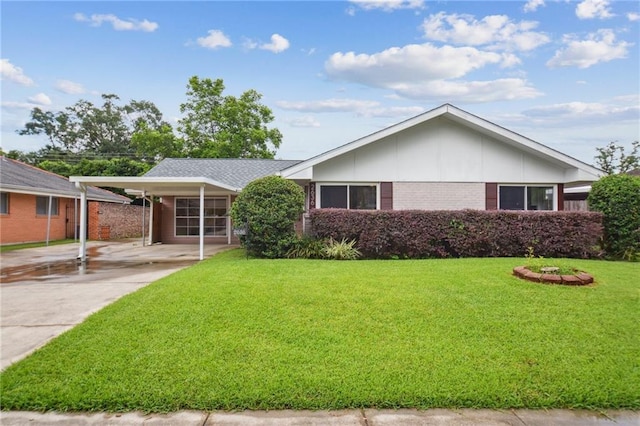2636 Somerset Dr, New Orleans, LA 70131 - ranch-style house with brick siding, a front yard, a carport, and driveway
