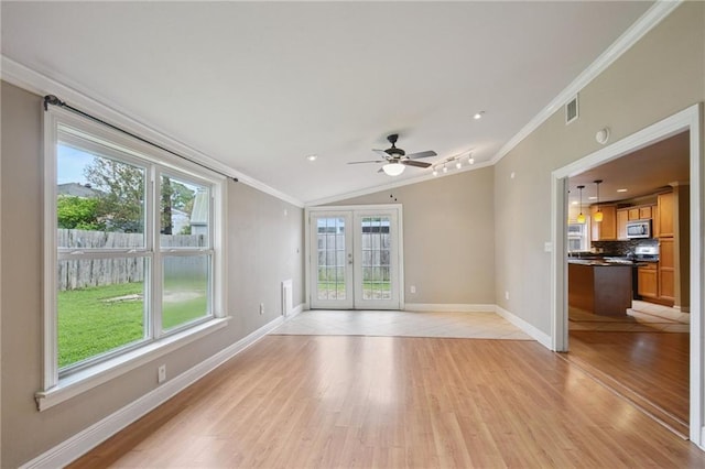 2636 Somerset Dr, New Orleans, LA 70131 - unfurnished living room featuring ornamental molding, light wood-type flooring, healthy amount of natural light, french doors, and lofted ceiling
