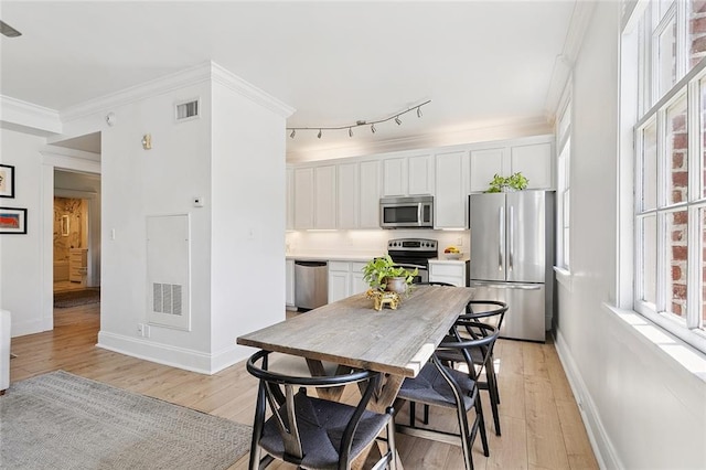 1783 Coliseum St Unit H, New Orleans, LA 70130 - kitchen with stainless steel appliances, white cabinets, light wood-style flooring, and crown molding