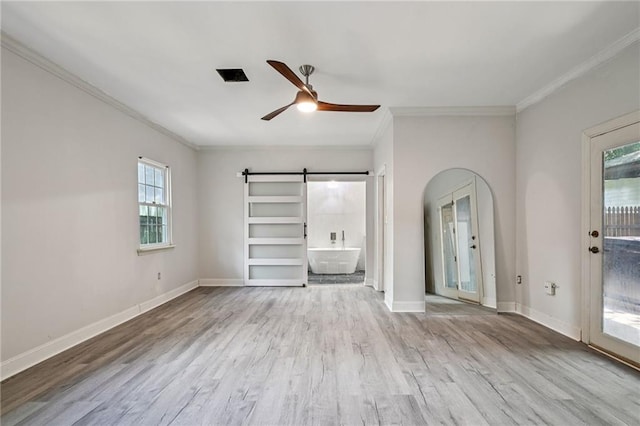 325 Jasmine Dr, Mandeville, LA 70471 - unfurnished living room with crown molding, a barn door, ceiling fan, and wood finished floors