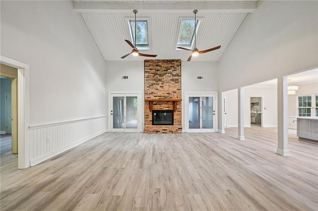 325 Jasmine Dr, Mandeville, LA 70471 - unfurnished living room with high vaulted ceiling, a fireplace, ceiling fan, and wood finished floors