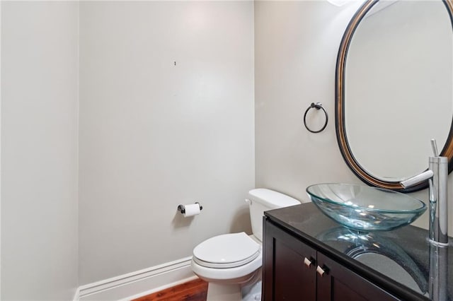 125 Broadway St, New Orleans, LA 70118 - half bathroom featuring vanity and wood finished floors