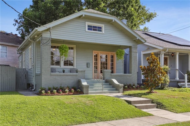 2303 Wisteria St, New Orleans, LA 70122 - bungalow with covered porch, brick siding, and solar panels