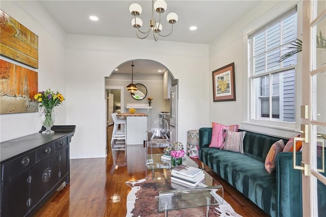 2303 Wisteria St, New Orleans, LA 70122 - living area with arched walkways, dark wood-type flooring, a chandelier, and recessed lighting