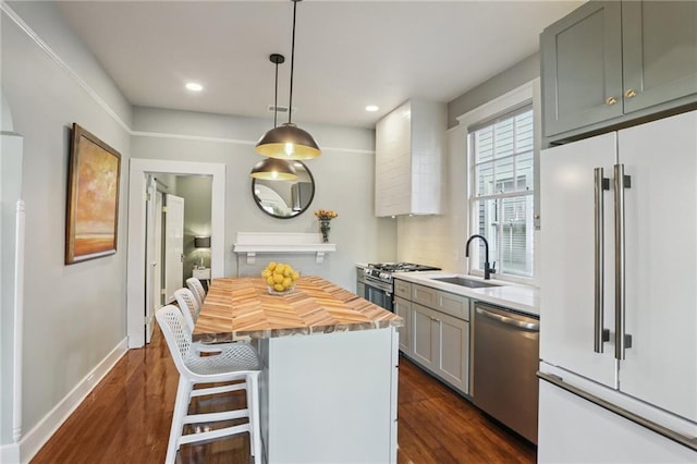 2303 Wisteria St, New Orleans, LA 70122 - kitchen with appliances with stainless steel finishes, wood counters, dark wood-style flooring, a kitchen island, and a breakfast bar