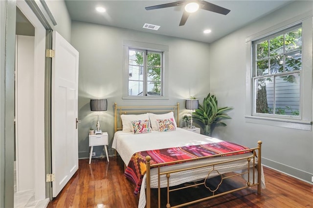 2303 Wisteria St, New Orleans, LA 70122 - bedroom with multiple windows, hardwood / wood-style floors, and a ceiling fan