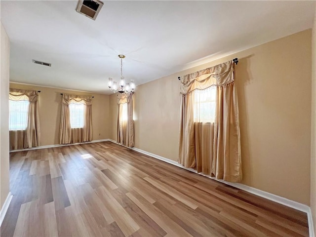 6012 Bridget St, Metairie, LA 70003 - empty room featuring a chandelier and wood finished floors