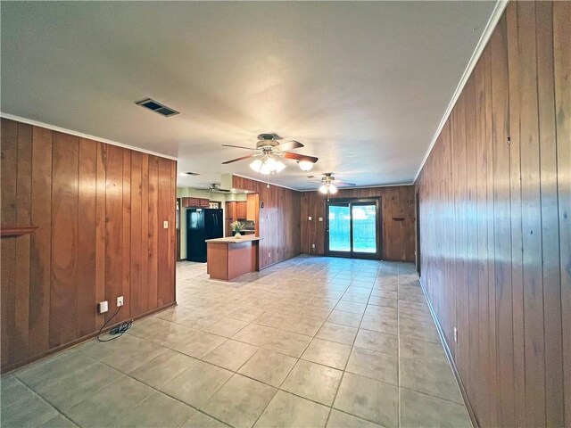 6012 Bridget St, Metairie, LA 70003 - unfurnished living room featuring wood walls, ceiling fan, light tile patterned floors, and ornamental molding