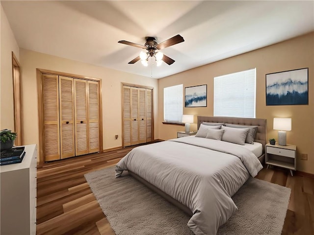 6012 Bridget St, Metairie, LA 70003 - bedroom featuring two closets, dark wood-style flooring, and a ceiling fan