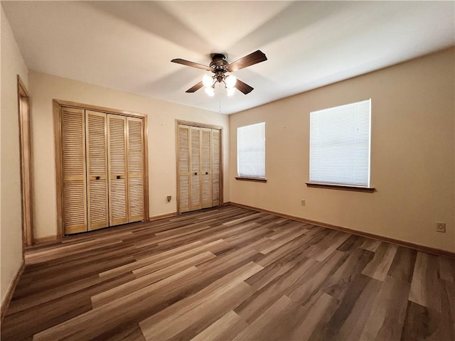 6012 Bridget St, Metairie, LA 70003 - unfurnished bedroom featuring two closets, wood finished floors, and ceiling fan