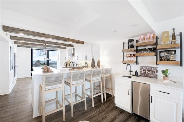 300 Lake Marina Ave Unit 14Dbw, New Orleans, LA 70124 - kitchen with refrigerator, wall chimney exhaust hood, dark wood-style flooring, white cabinets, and open shelves