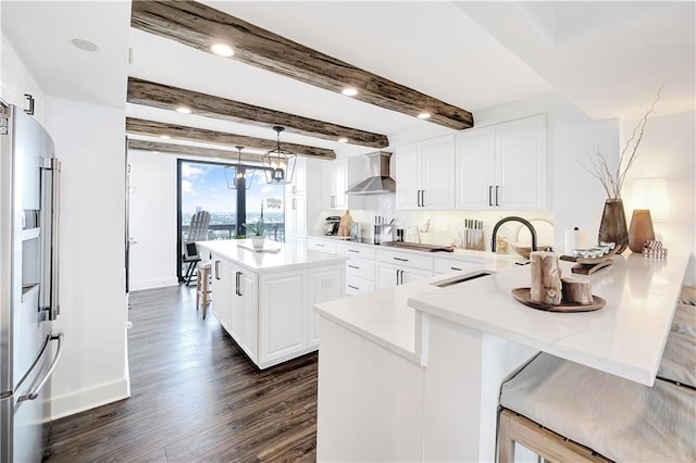 300 Lake Marina Ave Unit 14Dbw, New Orleans, LA 70124 - kitchen featuring wall chimney exhaust hood, high quality fridge, a peninsula, dark wood-style floors, and white cabinets