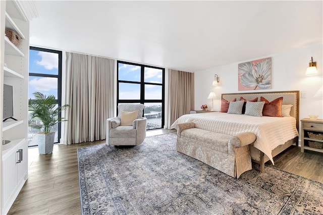 300 Lake Marina Ave Unit 14Dbw, New Orleans, LA 70124 - bedroom featuring wood finished floors, multiple windows, and a wall of windows