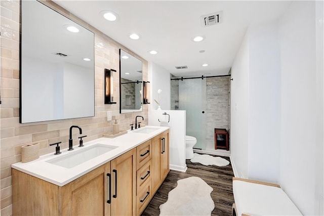 300 Lake Marina Ave Unit 14Dbw, New Orleans, LA 70124 - full bath with double vanity, a stall shower, wood finished floors, recessed lighting, and decorative backsplash