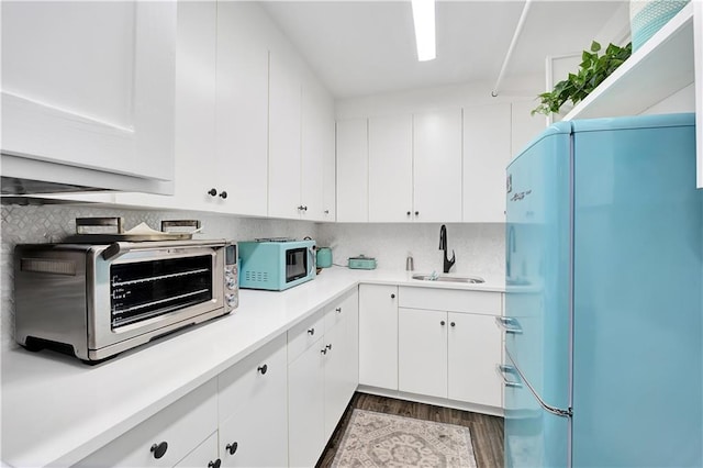 300 Lake Marina Ave Unit 14Dbw, New Orleans, LA 70124 - kitchen featuring freestanding refrigerator, light countertops, and decorative backsplash