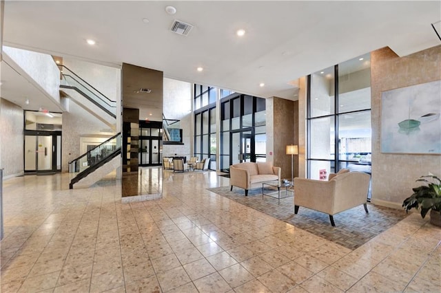 300 Lake Marina Ave Unit 14Dbw, New Orleans, LA 70124 - building lobby featuring expansive windows, stairs, a towering ceiling, and recessed lighting