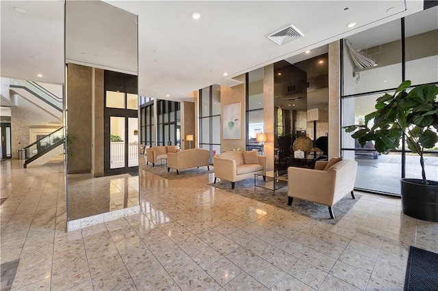 300 Lake Marina Ave Unit 14Dbw, New Orleans, LA 70124 - building lobby with stairway, a wall of windows, and recessed lighting