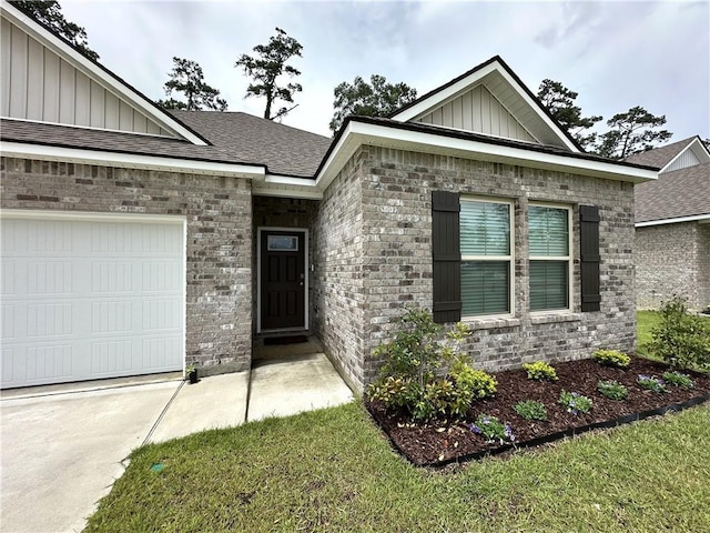 42423 Landing View Rd, Ponchatoula, LA 70454 - view of front of property featuring board and batten siding, a garage, brick siding, driveway, and a shingled roof