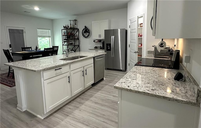 42423 Landing View Rd, Ponchatoula, LA 70454 - kitchen featuring stainless steel appliances, light wood-style flooring, and white cabinets