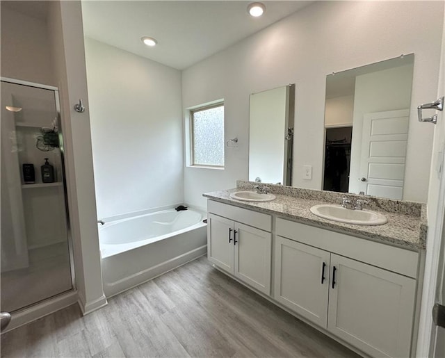 42423 Landing View Rd, Ponchatoula, LA 70454 - full bath with a stall shower, wood finished floors, a garden tub, double vanity, and a spacious closet