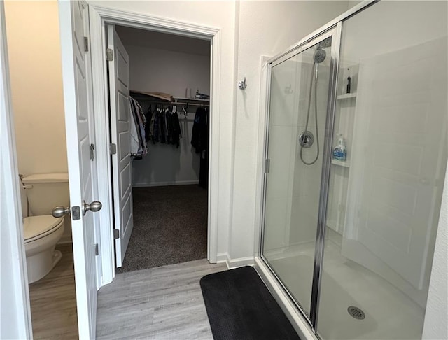 42423 Landing View Rd, Ponchatoula, LA 70454 - bathroom featuring a shower stall, a walk in closet, and wood finished floors