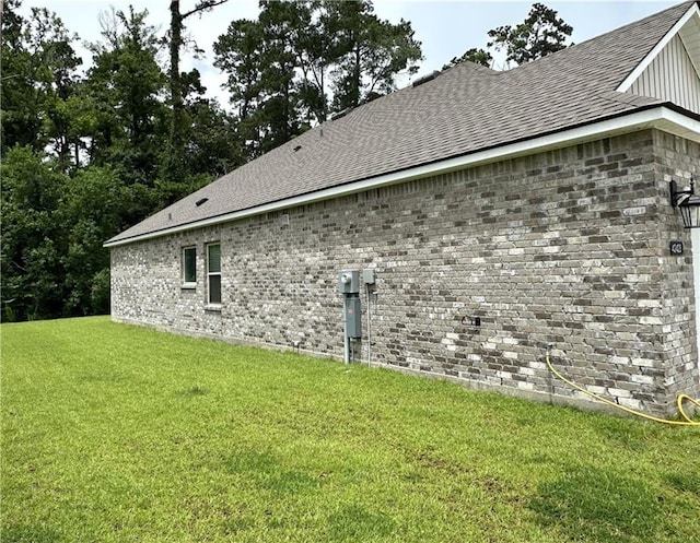 42423 Landing View Rd, Ponchatoula, LA 70454 - view of side of property with a yard, a shingled roof, and brick siding