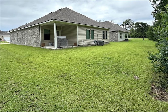 42423 Landing View Rd, Ponchatoula, LA 70454 - back of property featuring a patio, a lawn, and a shingled roof