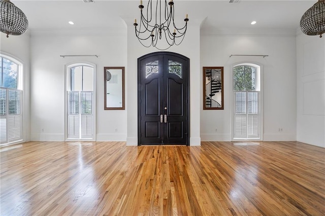 6978 Canal Blvd, New Orleans, LA 70124 - foyer entrance featuring a chandelier, crown molding, light wood-style flooring, and recessed lighting