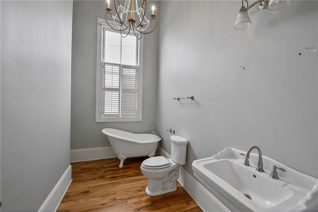 6978 Canal Blvd, New Orleans, LA 70124 - full bathroom with a freestanding bath, a chandelier, and wood finished floors