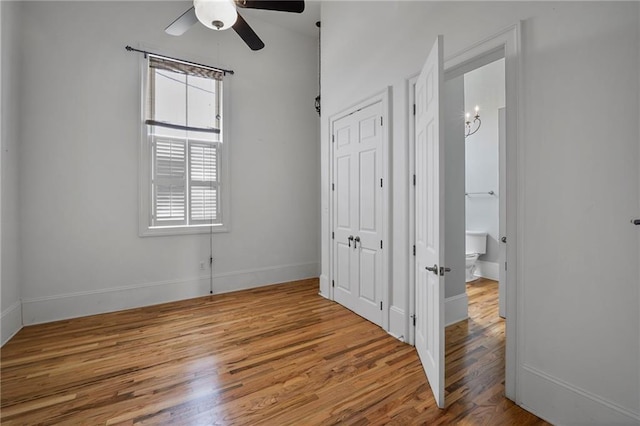 6978 Canal Blvd, New Orleans, LA 70124 - unfurnished bedroom featuring wood finished floors, a ceiling fan, connected bathroom, and a closet